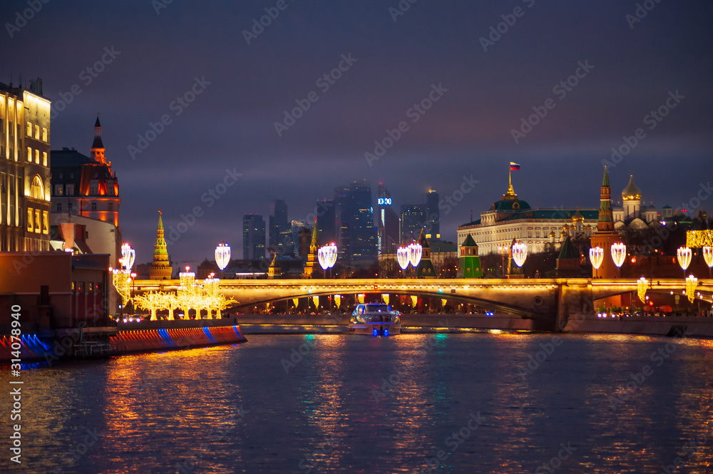 Moscow, Russia - January 03, 2020:   View of the Moscow Kremlin and the Moskva river in the evening with Christmas illumination.