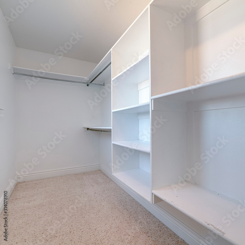 Square Empty white fitted interior of walk-in wardrobe
