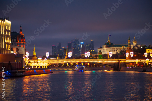 Moscow, Russia - January 03, 2020: View of the Moscow Kremlin and the Moskva river in the evening with Christmas illumination.