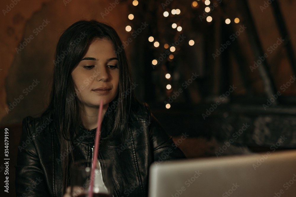 Beautiful woman working on laptop in bar Beautiful woman working on laptop in bar