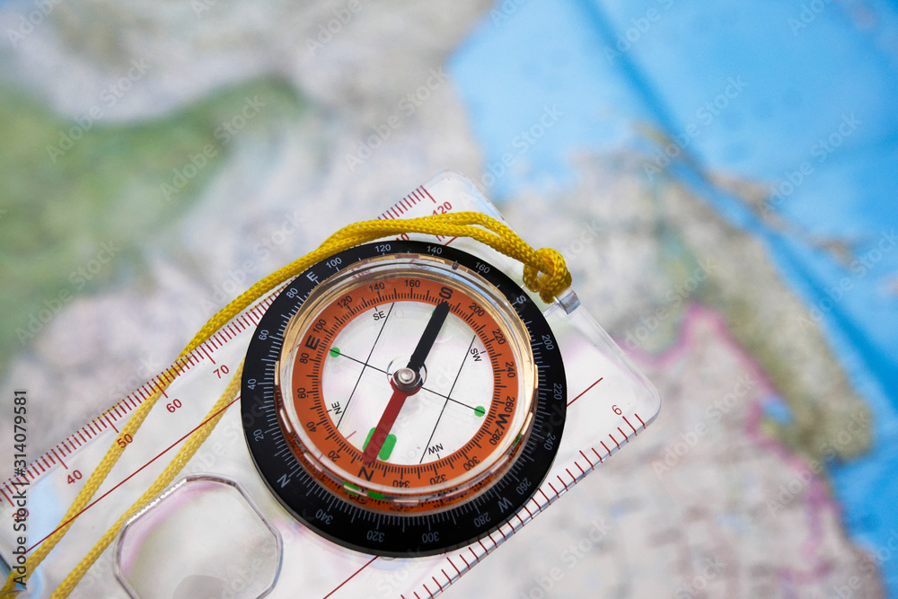 Naklejka premium Compass on a map background.