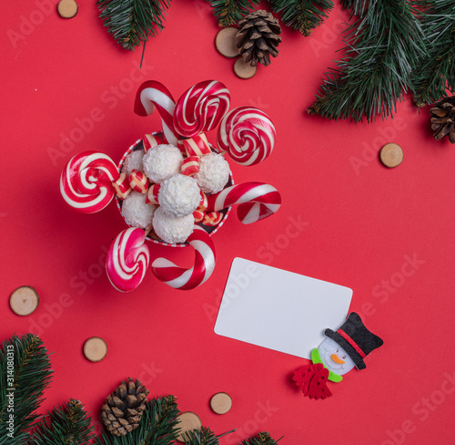 Christmas card. Invitation card on a red background. Surprise box with sweets. Interesting proposition for you. photo