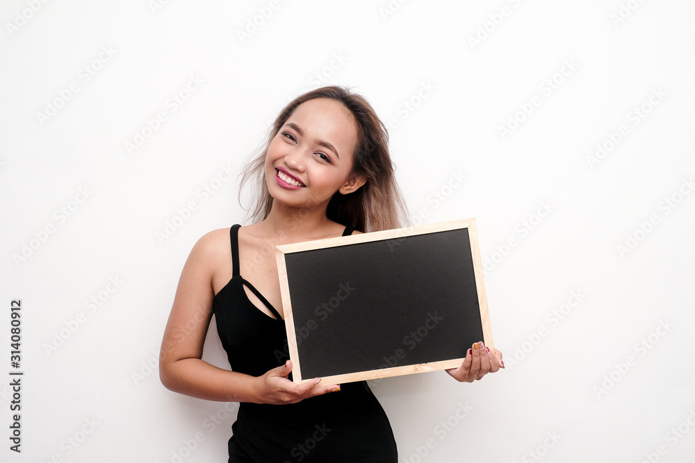 Young girl holding blank black board or sign. Young girl holding blank black board or sign.