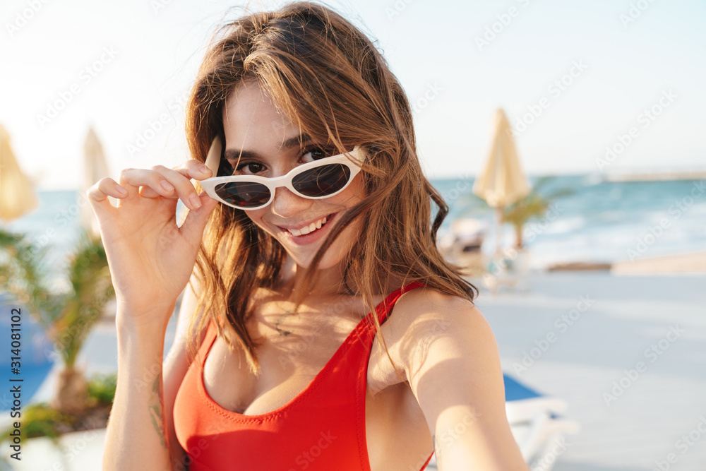 Photo of happy joyful woman smiling and taking selfie photo Photo of happy joyful woman smiling and taking selfie photo