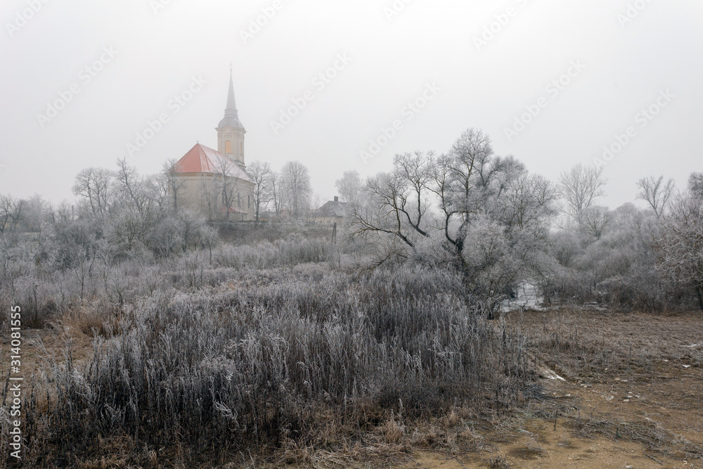 Frosty trees and bushes around the church of  Sajopuspoki on a winter day