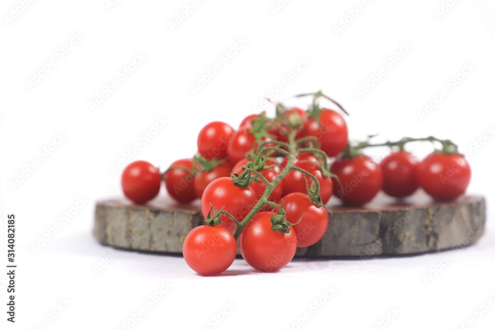 vine tomatoes on wooden cutting board with white background vine tomatoes on wooden cutting board with white background