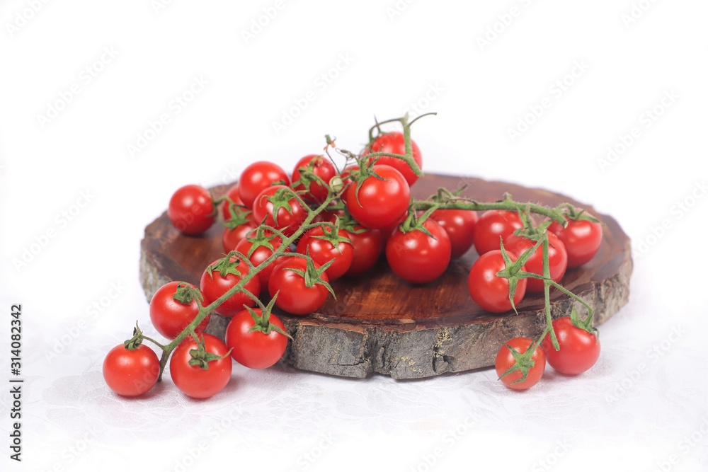 vine tomatoes on wooden cutting board with white background vine tomatoes on wooden cutting board with white background