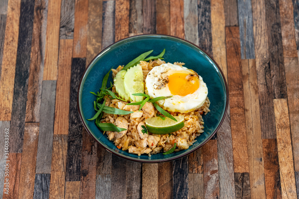Wok rice cooked with soy sauce, vegetables and chicken pieces. Wok rice cooked with soy sauce, vegetables and chicken pieces.
