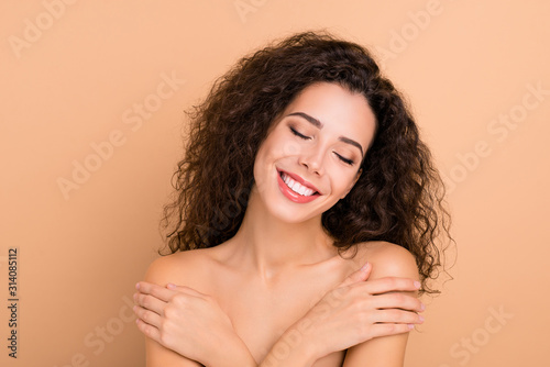 Close up photo beautiful she her lady overjoyed hands arms palms hold herself shoulder skin healthy soft silky shiny ideal condition breast cancer protection wear no clothes isolated beige background