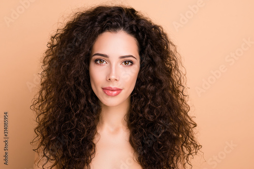 Close up photo beautiful amazing she her lady healthy brown curls ideal brilliant appearance plump allure tempting big lips balm wear no clothes isolated beige pastel background