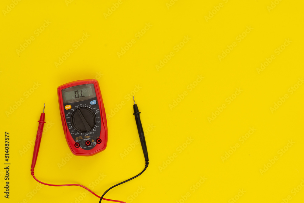 Top view multimeter on yellow background with measuring tips. Inspection concept Top view multimeter on yellow background with measuring tips. Inspection concept