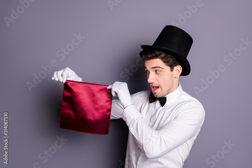 Funny funky magician start his wonderful focus hold hand red napkin look say abr Fototapet