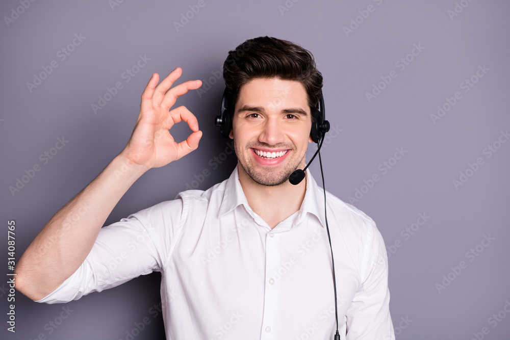 Portrait of cool confident customer support worker have help line with clients excellent feedback show okay sign wear headset formal wear clothing isolated over grey color background Portrait of cool confident customer support worker have help line with clients excellent feedback show okay sign wear headset formal wear clothing isolated over grey color background