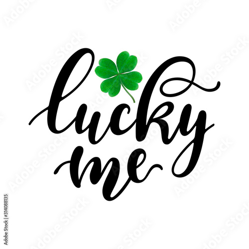 Lucky me - black handwritten lettering with four-leaf shamrock isolated on white background. 17 March St. Patrick's, Valentine's Day artwork. Good for greeting cards, t-shirt, and mug design.