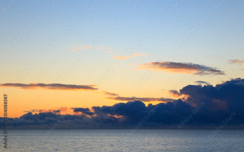 Bright cumulus clouds against the blue sky. Sunset sky Natural background. seascape