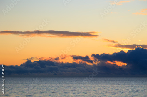 Bright cumulus clouds against the blue sky. Sunset sky Natural background. seascape