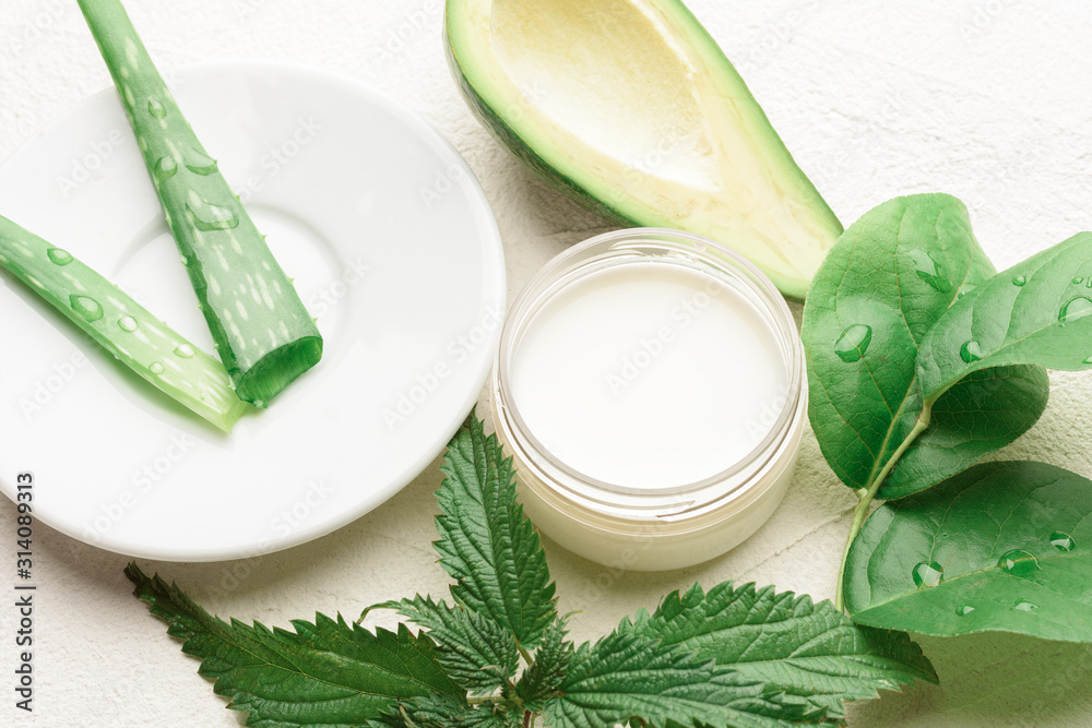 Natural aloe vera and avocado cosmetic closeup image. Handmade skin care products. Facial treatment preparation and refreshing cream background.  flat lay composition with natural cosmetic products.