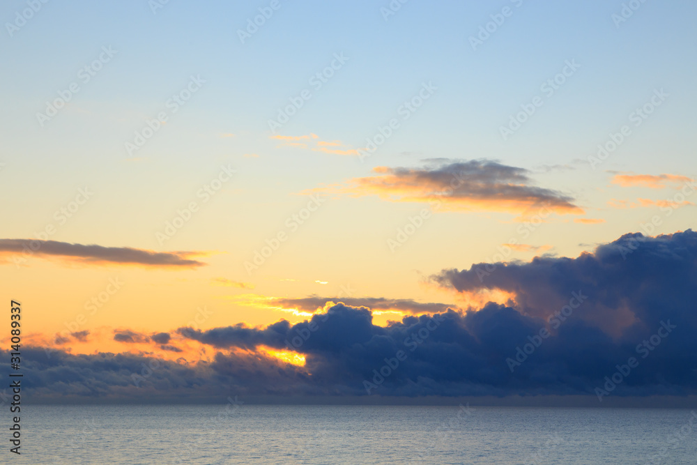 Obraz premium Bright cumulus clouds against the blue sky. Sunset sky Natural background. seascape