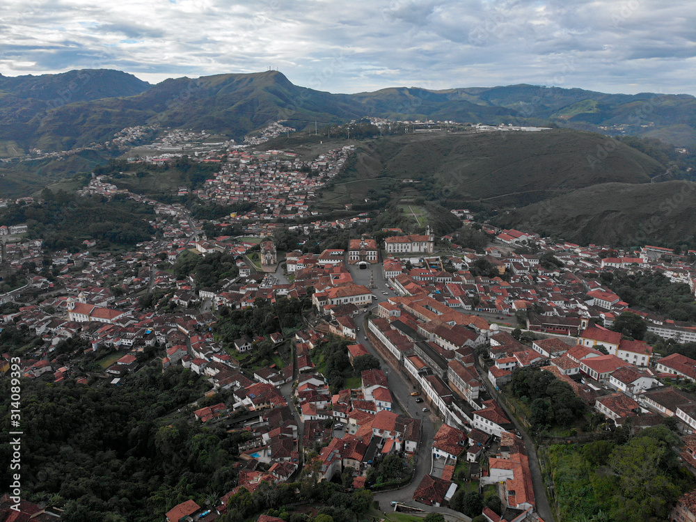 Wide view of colonial mining city centre Ouro Preto in Minas Gerais, Brazil, with surrounding mountains in the background seen from a high vantage point