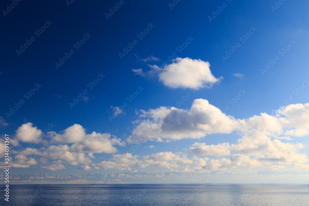 Bright cumulus clouds against the blue sky. Sunset sky Natural background. seascape