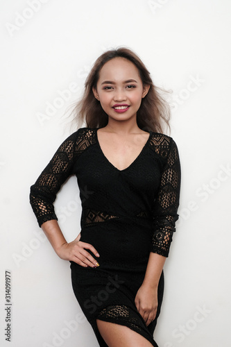 Young sexy girl wearing a black long lace dress, shot on isolated white background. © Rafael