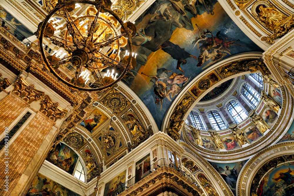 Icons and decorated dome with windows in the interior of the St Isaac Cathedral in St Petersburg, Russia