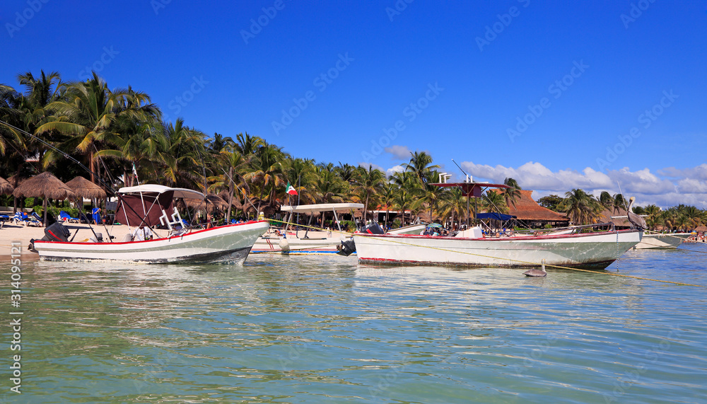 Akumal Bay and Caribbean white beach including fishing boats in Riviera Maya, coast of Yucatan, Quintana Roo, Mexico