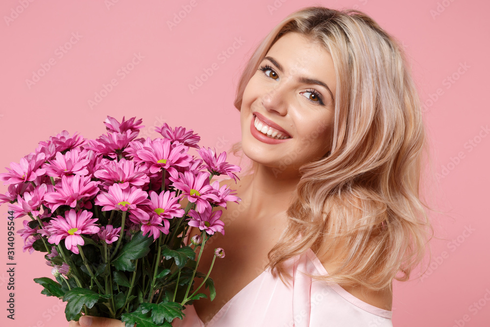 Smiling young woman girl in party outfit celebrating isolated on pastel pink background. People lifestyle Valentine's Day Women's Day birthday holiday party concept. Hold beautiful bouquet of flowers. Smiling young woman girl in party outfit celebrating isolated on pastel pink background. People lifestyle Valentine's Day Women's Day birthday holiday party concept. Hold beautiful bouquet of flowers.