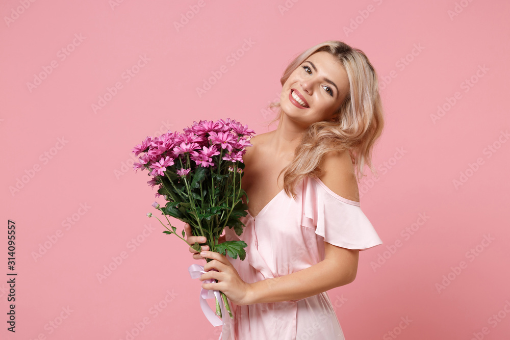 Pretty young woman girl in party outfit celebrating isolated on pastel pink background. People lifestyle Valentine's Day Women's Day birthday holiday party concept. Hold beautiful bouquet of flowers. Pretty young woman girl in party outfit celebrating isolated on pastel pink background. People lifestyle Valentine's Day Women's Day birthday holiday party concept. Hold beautiful bouquet of flowers.