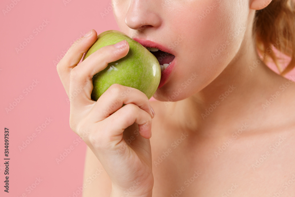 Close up cropped half naked woman 20s perfect skin nude make up hold apple isolated on pastel pink wall background studio portrait. Skin care healthcare cosmetic procedures concept. Mock up copy space Close up cropped half naked woman 20s perfect skin nude make up hold apple isolated on pastel pink wall background studio portrait. Skin care healthcare cosmetic procedures concept. Mock up copy space