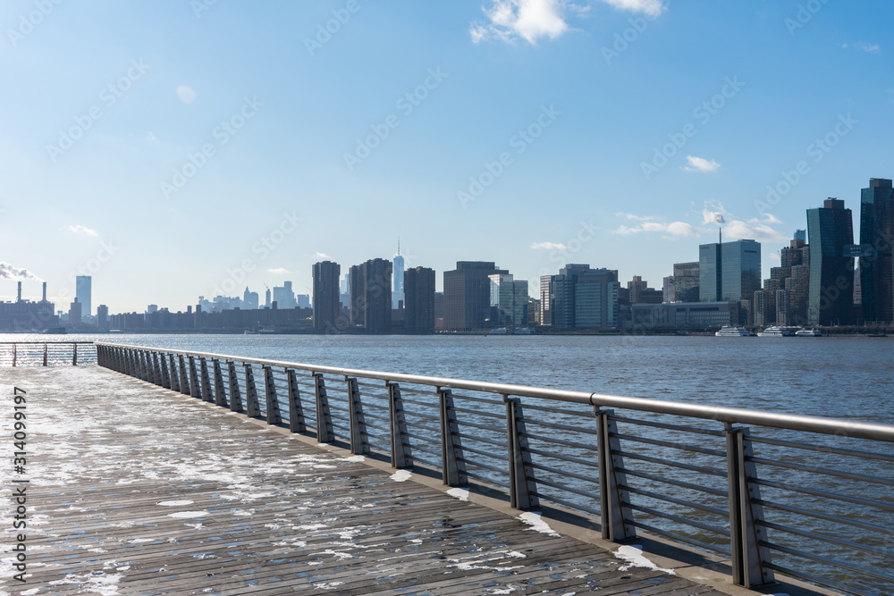 Waterfront along the East River in Long Island City Queens New York looking out towards the Manhattan Skyline Waterfront along the East River in Long Island City Queens New York looking out towards the Manhattan Skyline