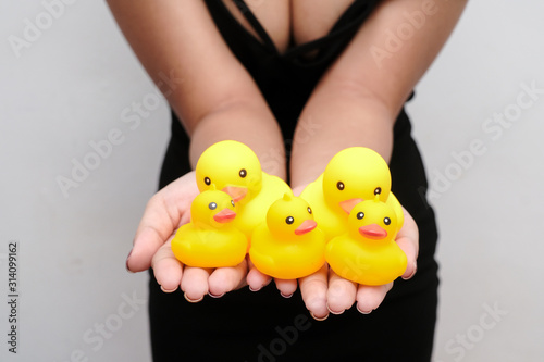 Young girl holding rubber duck in celebration of National Rubber duck day.