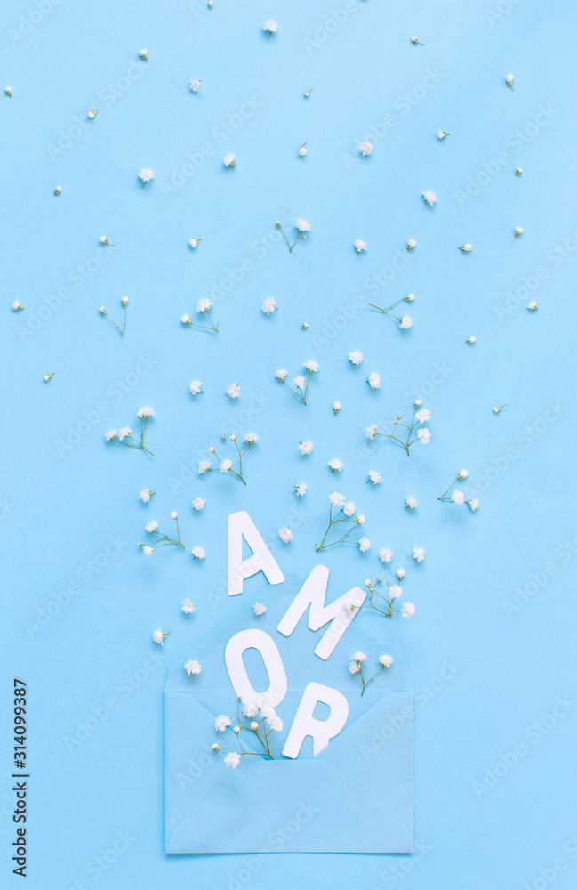 Flowers, envelope and text  AMOR on a light blue background - obrazy, fototapety, plakaty 