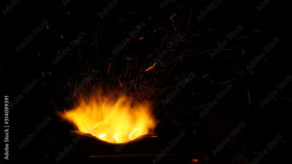 Red hot sparks motion of fire night flying from flame 