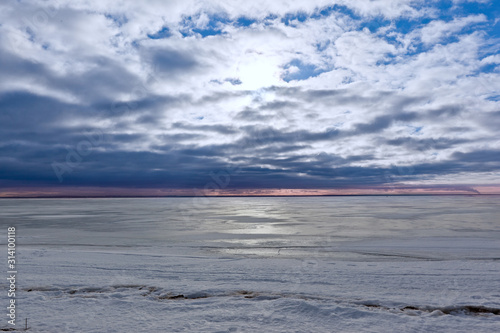 Sunset in winter on the shore of the frozen Baltic Sea