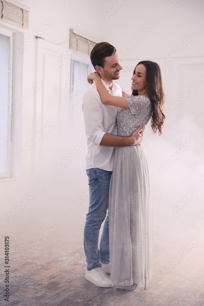 Lovely young couple dancing together in ballroom Lovely young couple dancing together in ballroom