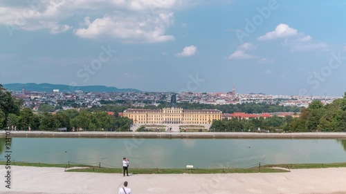 Beautiful view of famous Schonbrunn Palace timelapse with Great Parterre garden and lake in Vienna, Austria. City panorama on a background photo