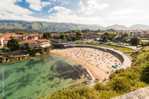 Llanes, Spain. Views of the Playa de El Sablon, a famous beach in the seaside and port town of Llanes, in Asturias photo