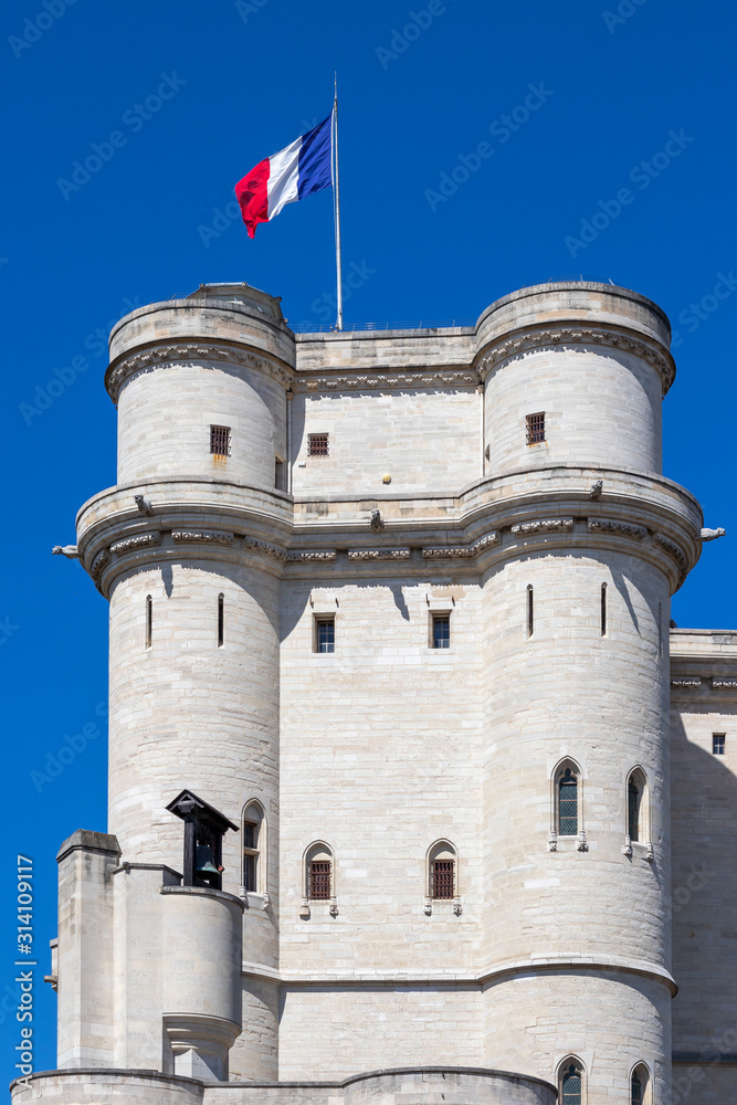 Chateau de Vincennes in Paris with French national flag