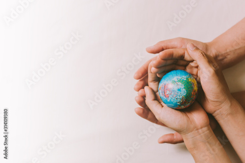 Hands couple holding globe, love, valentine, health care, donation and family insurance concepts, World Heart Day, save world, prayer.