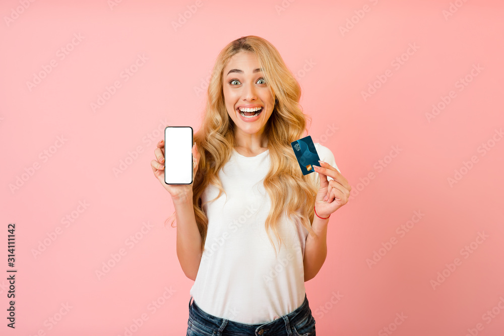 Online banking. Excited woman showing smartphone and credit card Online banking. Excited woman showing smartphone and credit card