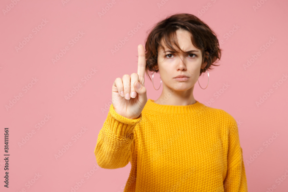 Young woman girl in yellow sweater posing isolated on pastel pink background. People lifestyle concept. Mock up copy space. Touch something like push click on button, point at floating virtual screen. Young woman girl in yellow sweater posing isolated on pastel pink background. People lifestyle concept. Mock up copy space. Touch something like push click on button, point at floating virtual screen.