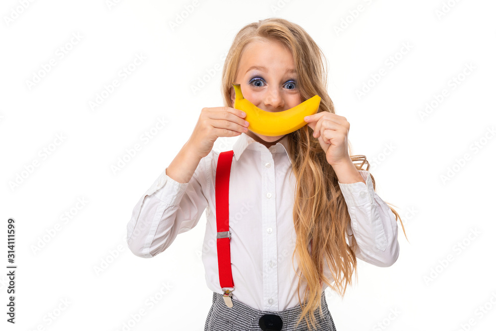 Pretty caucasian girl with long blonde hair smiles with banana isolated on white background Pretty caucasian girl with long blonde hair smiles with banana isolated on white background