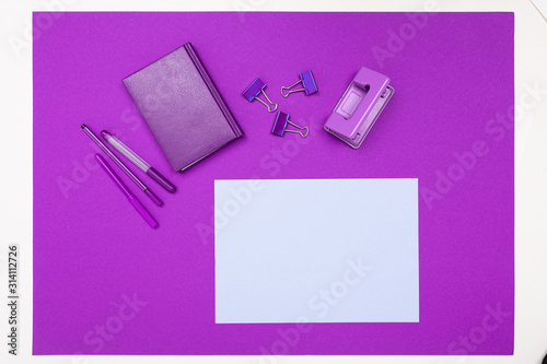 minimalism concept. stationery on a purple office desk