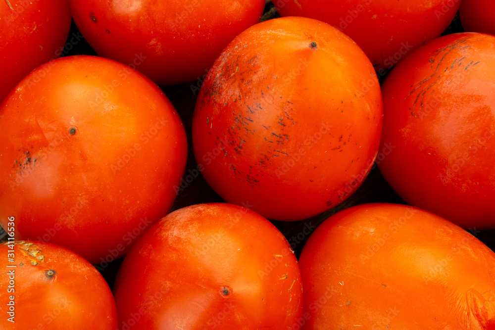 Fruit background of closeup on a box of fresh persimmon. Fruit background of closeup on a box of fresh persimmon.