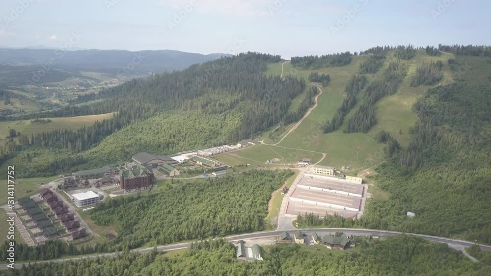 custom made wallpaper toronto digitalPlay, Carpathian Ukraine - 7 7 2019: Ski resort among green forested mountains in the summer. A hotel with pools of a wellness complex shot from a drone or a quadrocopter. Aerial photography