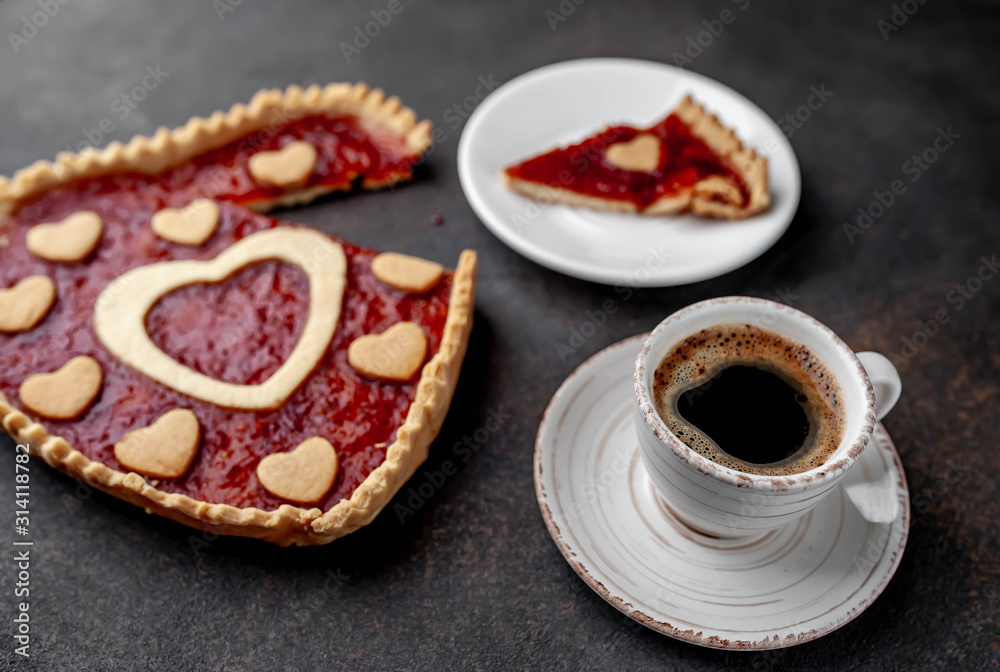 coffee, heart-shaped cake, a gift with a red ribbon for Valentine's Day on stone background, with copy space for your text. breakfast concept on saint's day Valentine. coffee, heart-shaped cake, a gift with a red ribbon for Valentine's Day on stone background, with copy space for your text. breakfast concept on saint's day Valentine.