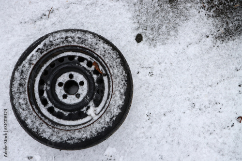 Snow powder tire. Black tire in the snow