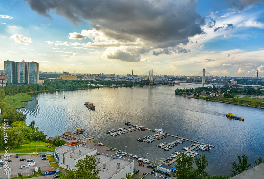 Top view of the Neva rivers and the urban Rybvtskoye microdistrict in St. Petersburg.