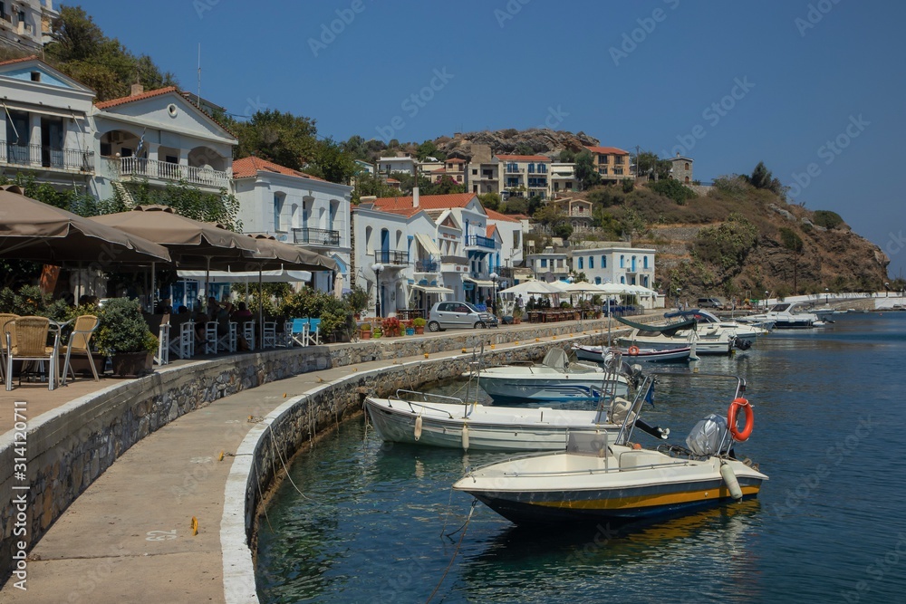 promenade with mediterranean flair at the enchanting harbor of Evdilos, Ikaria, Greek Islands, Greece